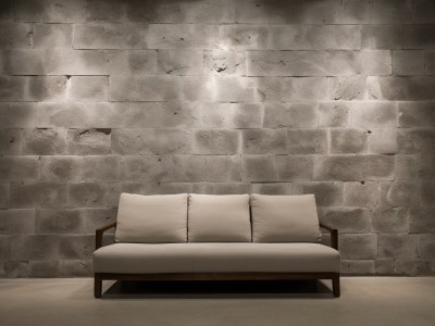 White Couch In Front Of A Stone Wall